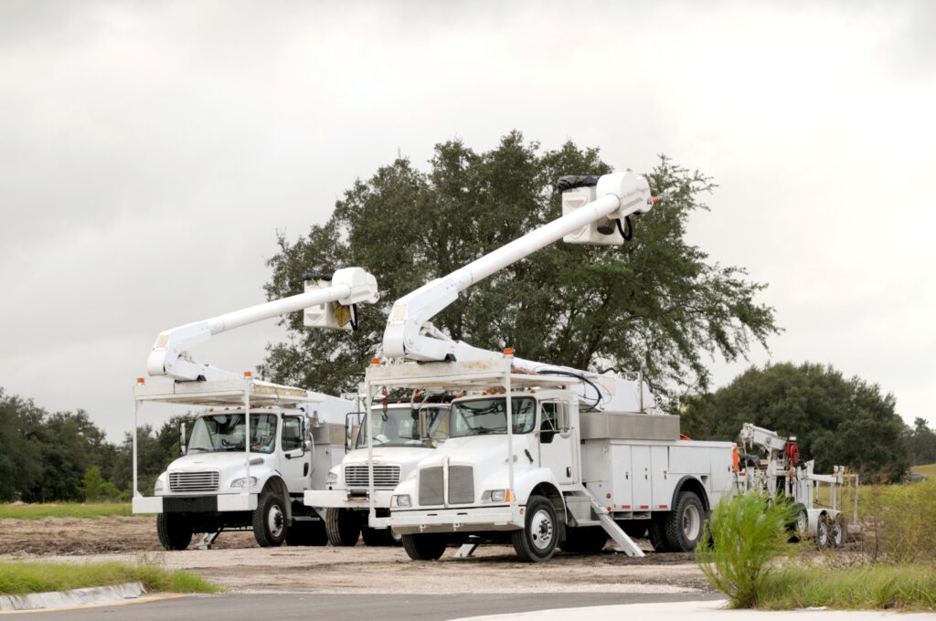 Three parked bucket trucks