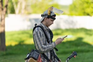 Tree care worker looking at mobile device