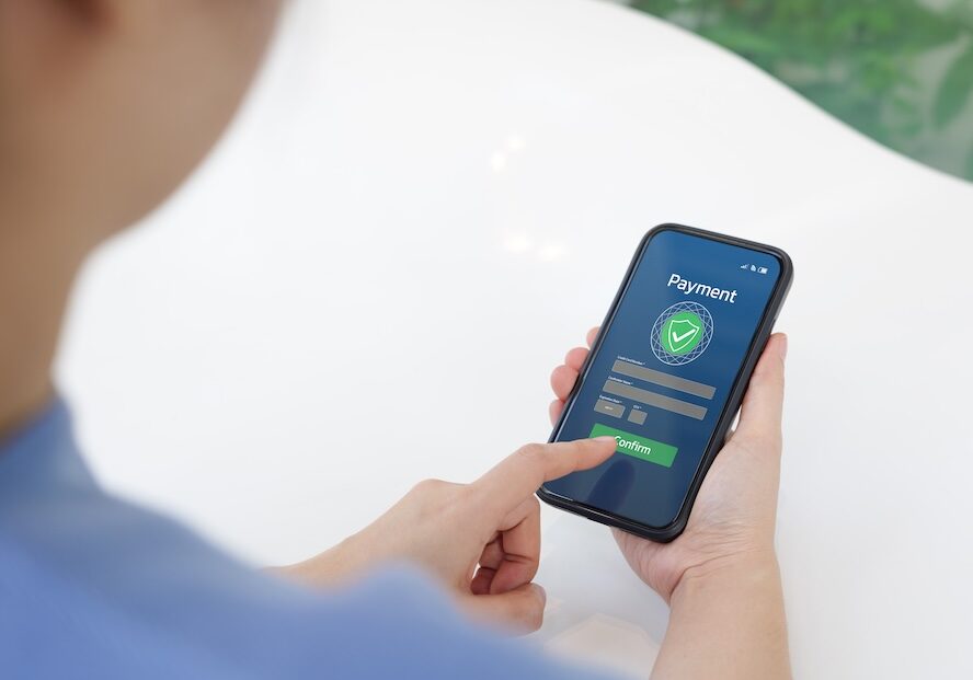 Secure Online Payment Transaction Process concept. Person confirming a secure online payment using a credit card through a digital interface with verification tick symbol. Internet banking, fintech, Mobile Payment Processing