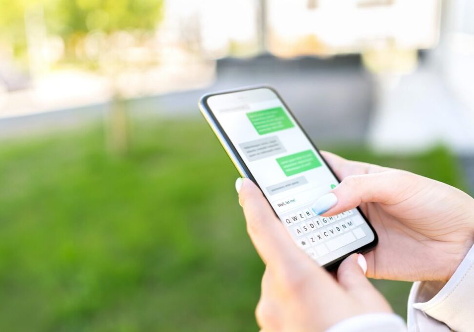 Person texting on phone while outside
